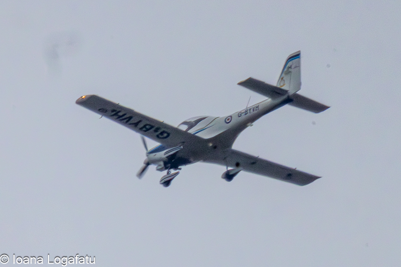 Bright aircraft soaring through the cloudy sky